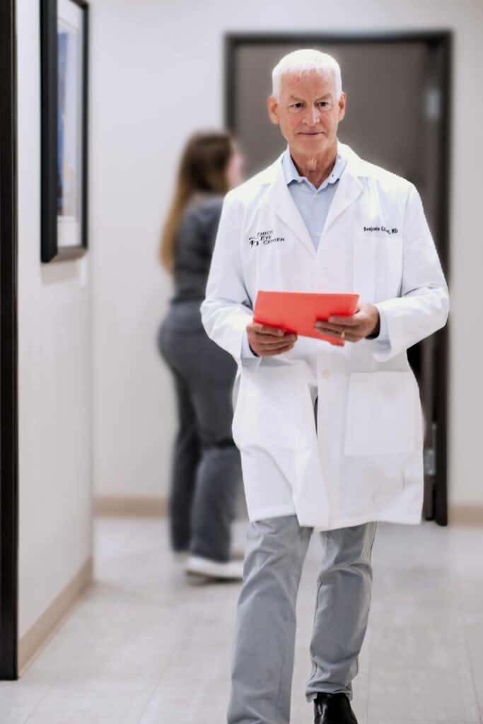 dr. gilbert walking down hall with red envelope