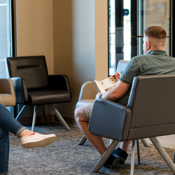 man sitting in waiting room chair